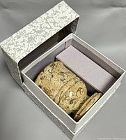 Opened cardboard box showing the jasper stone mortar and pestle set nestled inside, confirming original packaging.