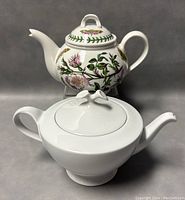 Two porcelain teapots together, one floral from Portmeirion and one white from Hutschenreuther