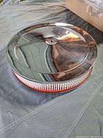 Top view of the 14-inch chrome air cleaner showing the reflective chrome cover and mesh sides with new Fram filter inside.