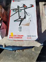 Front of box showing image of assembled bike carrier rack for two bikes, brand Allen, model Deluxe Trunk Bike Carrier 2 Bike Rack.