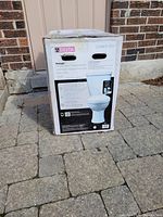 Front of sealed box showing Delta logo, model C43801-WH and image of assembled toilet.