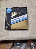 Front of Gibson Electric Guitar Strings box showing branding, gauge, and specifications.