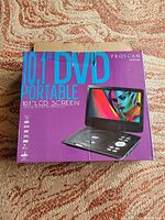 Box of Proscan 10.1 inch portable DVD player showing brand and model on purple packaging.
