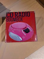 Box of the pink Proscan CD radio boombox showing branding and color