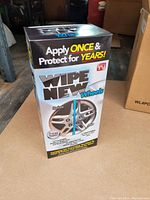 Front view of one Wipe New Wheels kit box showing the branding, claims of one application protection for years, and before/after wheel images.