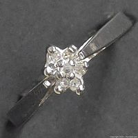 Close-up image showing the diamond cluster on the 10kt gold ring, highlighting the sparkle and setting of the stones.