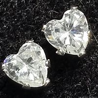Close-up image of pair of heart-shaped cubic zirconia earrings set in 14kt gold.