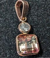 Close-up photo showing the pink tourmaline and diamond set in rose gold pendant.