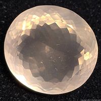 Front view of the faceted oval rose quartz gemstone showing light pink translucency and checkerboard cut.