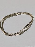 Sterling silver multi-strand twisted necklace laid flat showing overall design.