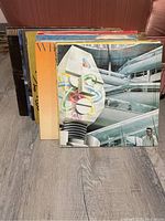 Photo of 12 vinyl records showing album cover art, various artists and styles