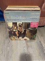 Front view of the vinyl records showing the top record, Breakfast at Tiffany's soundtrack by Henry Mancini in original sleeve with sticker about Academy Awards wins.