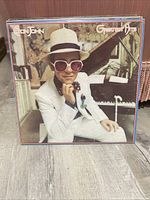 Front cover of Elton John Greatest Hits album with Elton John in white suit and hat