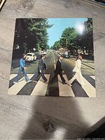 Front cover photo of The Beatles Abbey Road album showing the iconic zebra crossing photo of the four band members walking.