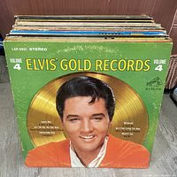 Stack of Elvis Presley LPs, front shows Elvis’ Gold Records Vol. 4