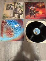 Four 12-inch vinyl records with visible album covers including Pink Floyd and Ozzy Osbourne.