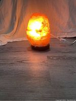 Photo of the salt lamp lit, showing the activated warm glow.