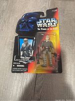 Front view of Star Wars The Power of the Force Han Solo action figure in original package, showing figure and graphics.