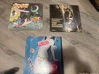 Three vinyl records by The Rolling Stones displayed on the floor: 'Harlem Shuffle', 'December's Children - Mono', and 'Undercover of the Night'.