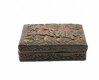 Side and corner view of the rectangular carved cinnabar and lacquer trinket box, showing depth and relief detail in carvings and floral border detail.