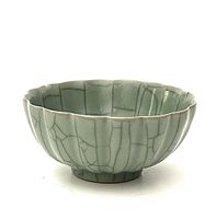 Side view of lotus-shaped celadon crackled glaze bowl showing shape and glaze details.
