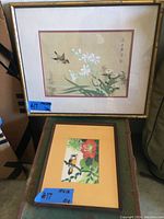 Two framed Japanese bird prints shown together, the larger 'Kamikaze Sparrow' in a gold frame above the smaller Jay print with orange and green matting.