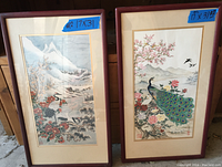 Photo of two framed Japanese bird prints side by side showing full artwork and frames.
