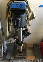 Full view of the Harbor Freight standing machine press, showing motor housing, vertical column, base plate, and control lever.