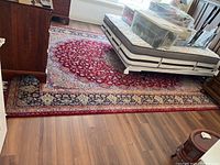 Full view of rug under mattress and boxes, showing overall pattern and color