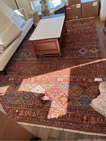 Full view of rug under coffee table on hardwood floor