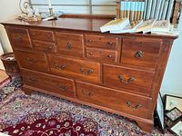 Front view of dresser showing all twelve drawers and metal pulls