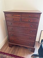 Front view of full dresser showing eight drawers and mahogany finish