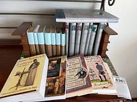 Photo showing Jane Austen softcover books and other classic literature softcover books arranged on or near wooden bookends.