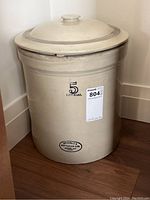 Full view of large beige stoneware crock with lid and visible labeling '5 Imperial' and maker's mark.