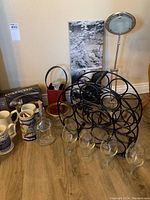 Wide view of bar items including wine rack, beer steins, corkscrew opener, glassware, and containers.