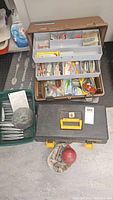 Fishing tackle boxes with various lures and accessories organized inside