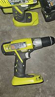 Ryobi cordless drill on concrete floor, showing side profile and grip