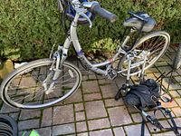 Side view of the Specialized Crossroads bike showing frame, tires, pedals, and some accessories.