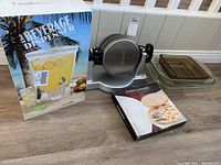 Lot setup showing beverage dispenser box, waffle maker, cheese mate set box, and casseroles