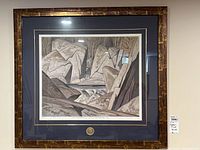Framed and matted limited edition print of a rock and water landscape by A. J. Casson with a gold medallion below, showing overall framing and matting.