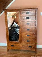 Front view of oak dresser cabinet showing mirror door and drawer layout