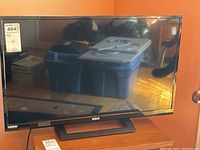 Front view of RCA 32-inch LED TV showing screen and stand