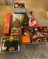 Overview of all items and boxes containing ornaments and decorations laid out on floor