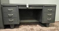 Full front view of the gray metal Cole-Steel tanker desk with six drawers and a center knee space.