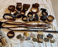 Overview of multiple belts and buckles laid out on a sheet