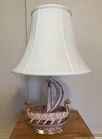 Front view of the lamp showing whole Viking ship base and the white shade