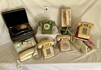 Group of thirteen vintage telephones varying in style, along with some boxed items including a hidden 1970s phone and phone accessories