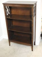 Front view of entire bookcase showing three shelves and top surface