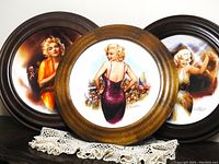 Three limited edition wood framed collectible plates featuring Marilyn Monroe, titled 'For Our Boys in Korea, 1954', 'Strasberg's Student', and 'Rising Star'. All plates have round wood frames with colorful art.