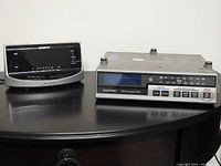GE Spacemaker radio and Sony Dream Machine radio side by side on a dark surface